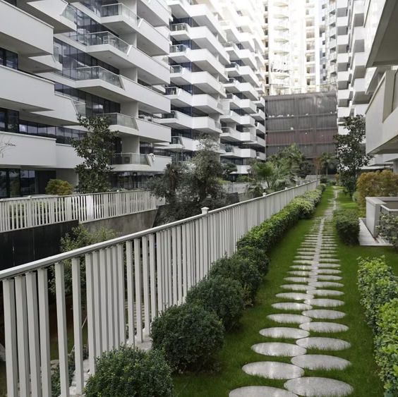 Planted walkway with stepping stones between residential towers at Star Towers